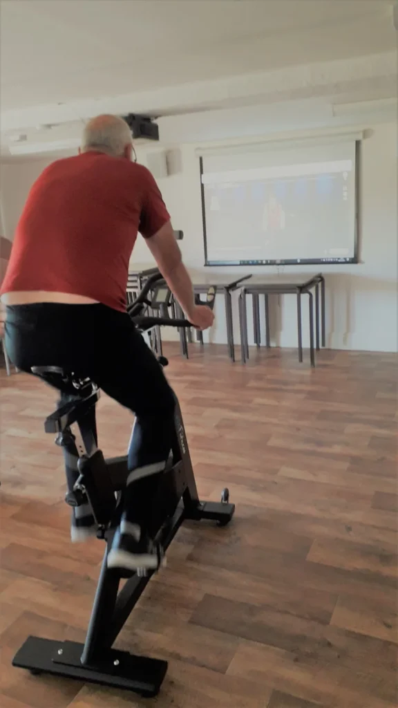 Male on spinning bike at Kirksanton Village Hall